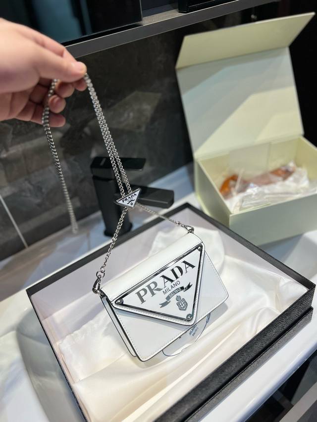 礼盒包装 上新 三角形徽标最初装点于mario Prada设计的旅行箱，此后藉由不同风格焕新重释，激发新颖的几何形状，承载概念化的内涵，每一系列皆有新意。这款简